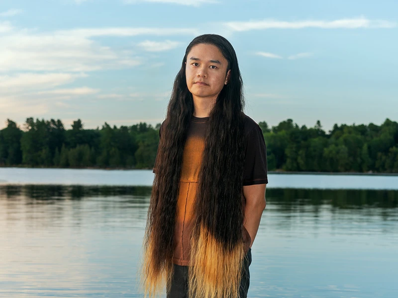 Jordan Wong standing in a body of water during a sunset
