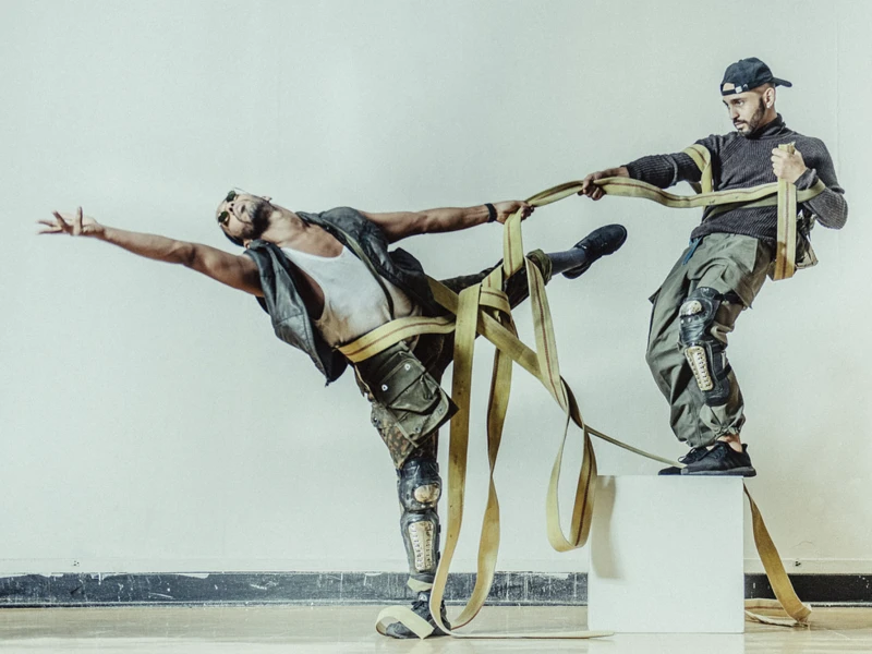 Two People Dancing With Ropes Held and Wrapped Around Them